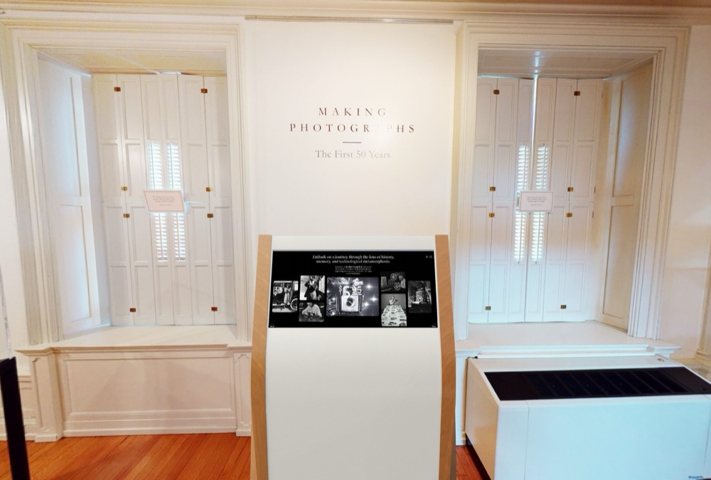 The Kodak timeline kiosk in front of the wall text for Making Photographs, The First 50 Years
